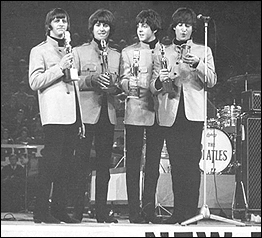 The Beatles accepting their award at the NME 1964-1965 Annual Poll Winners' All-Star Concert.