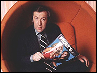 David Frost, talk show host of the 1950s, 1960s and 1970s, poses in a pop art chair.