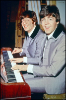John Lennon and Paul McCartney play a piano backstage at the Scala Theatre during the filming of A Hard Day's Night.