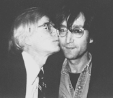 Andy Warhol gives John Lennon a kiss on the cheek at a public event in the late 1970s. Warhol and Lennon had a friendly relationship over the years.