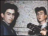 A young George Harrison is photographed with an equally young John Lennon in Liverpool, England.
