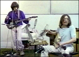 John Lennon (seated) and George Harrison during the Get Back session in 1969.