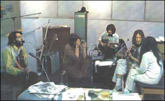 The Beatles at Abbey Road Studios recording Let It Be. Left to right: Paul McCartney, (unidentified photographer),George Harrison, John Lennon, and Yoko Ono.