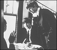 John Lennon and Ringo Starr on a train in a scene from their first feature film A Hard Day's Night.