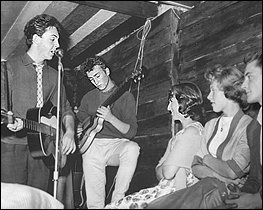 The Beatles performing at the Casbah Coffee Club. Left to right: Paul McCartney, John Lennon, Cynthia Powell (later Lennon) and two unknown teens.