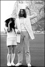 John Lennon and Yoko Ono post for a picture in front of the Rock of Gibraltar after they are married on March 20, 1969. John is holding their marriage license over his head.