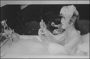 John Lennon in a bubble bath for a scene in the Beatles first feature film, A Hard Day's Night.