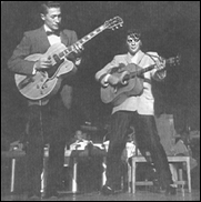 Elvis Presley performing for the first time in Las Vegas in 1956. Pictured left is guitarist, Scotty Moore.